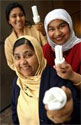 Three women holding energy efficiency lamps